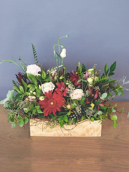 Floral box with red gerberas, alstroemerias, cream roses, and lisianthus. A vibrant, abundant gift supporting local South African florists.