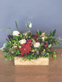 Floral box with red gerberas, alstroemerias, cream roses, and lisianthus. A vibrant, abundant gift supporting local South African florists.