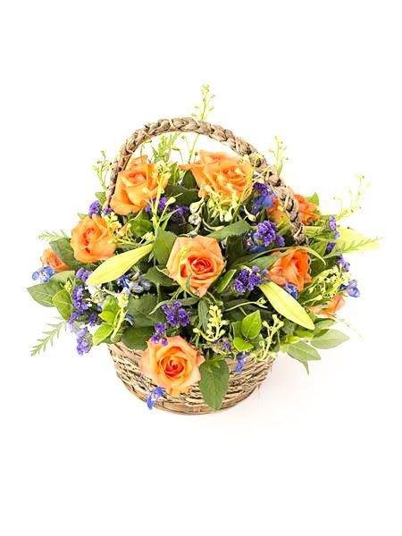 Butterfield Basket with orange roses, purple flowers, and greenery arranged in a woven basket for a heartwarming floral surprise.