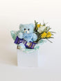 Gift box featuring a blue teddy bear labeled 'Boy' with chocolates and yellow flowers, part of Celebrate A Birth range for baby boys.