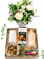 Serene gift box with white pillar candle, fresh floral arrangement, Lindt chocolate, luxury nougat, shortbread biscuits, and mixed nuts.