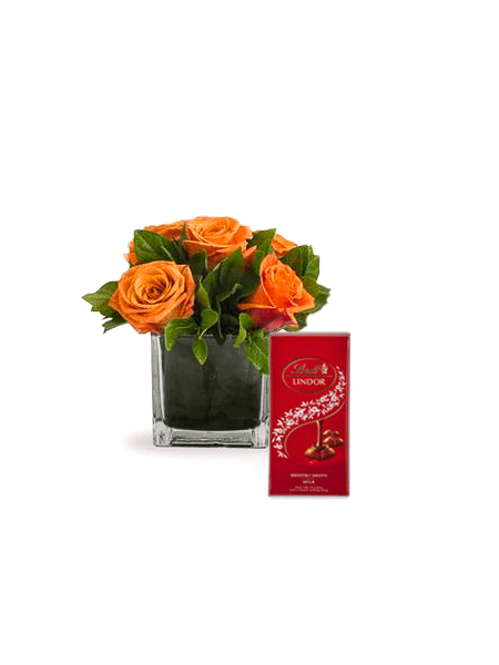 Orange roses in a glass vase with 100g Lindt chocolate, perfect as a sweet and thoughtful gift arrangement.
