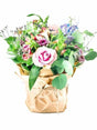 Pastel Posy bouquet with pink roses, blue delphiniums, and greenery in rustic brown wrapping, showcasing a delicate, soft floral arrangement.