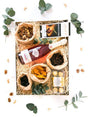 Gift box with non-alcoholic pink champagne, Lindt chocolate, mixed nuts, Ferrero Rocher, dried fruit, and Maltesers.