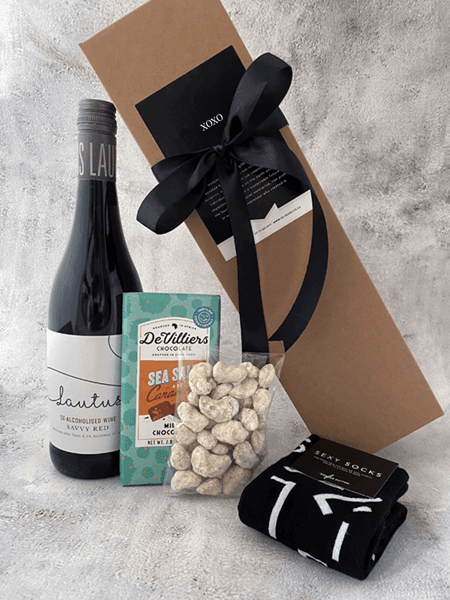 Gift set with Lautus non-alcoholic wine, chocolate slab, coated nuts, and funky socks promoting South African charity.