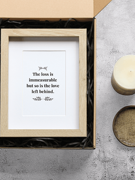 Sympathy gift box with a photo frame, bereavement card, vanilla candle, and ceramic tray, for showing support during loss.